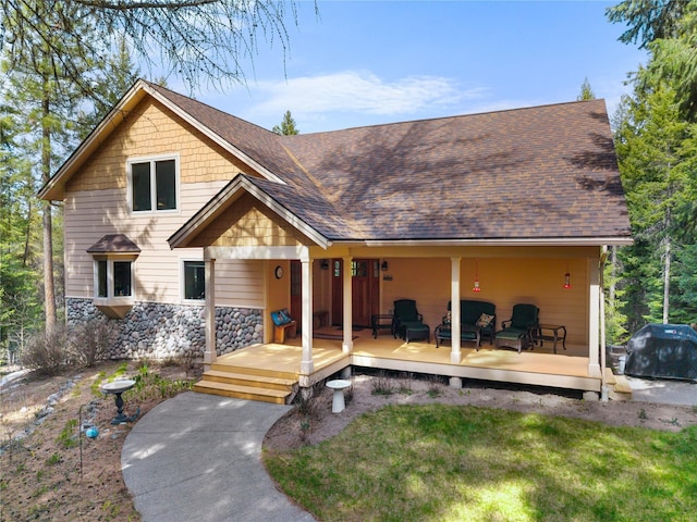 69 Fir Dr, Thompson Falls, MT 59873 - view of front of property featuring roof with shingles, stone siding, and a front yard