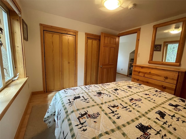 69 Fir Dr, Thompson Falls, MT 59873 - bedroom featuring light wood-style floors, baseboards, and multiple closets