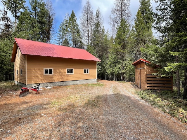 69 Fir Dr, Thompson Falls, MT 59873 - view of home's exterior featuring an outdoor structure and metal roof