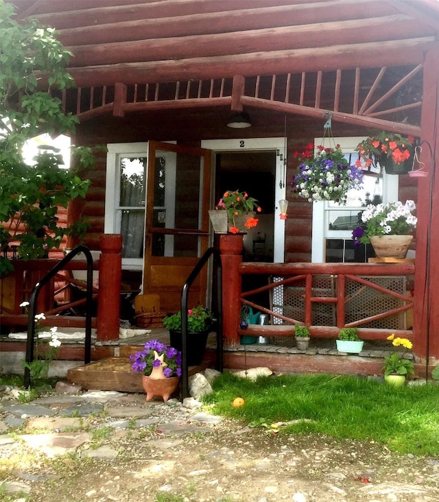 413 A St Unit 2, Hot Springs, MT 59845 - view of exterior entry featuring a porch and faux log siding