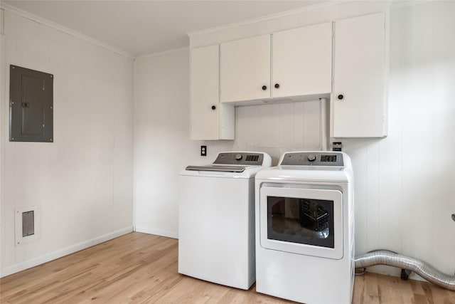 washroom featuring light wood-style floors, ornamental molding, cabinet space, and electric panel