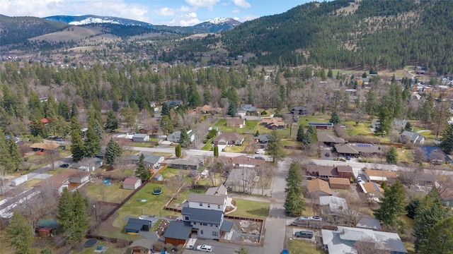 bird's eye view featuring a residential view, a view of trees, and a mountain view