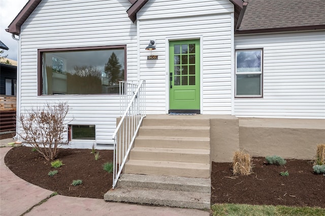 property entrance with a shingled roof
