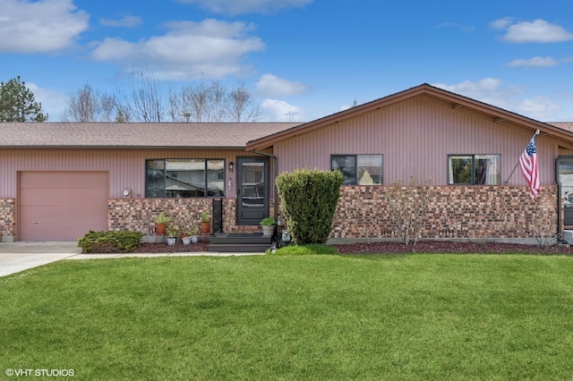 ranch-style house featuring a garage, brick siding, a front lawn, and concrete driveway
