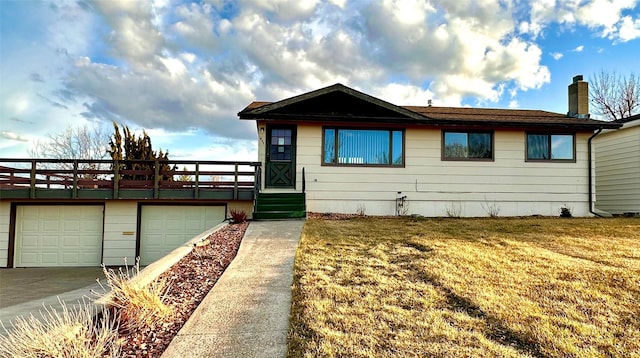 view of front of property with concrete driveway, a front yard, and a chimney