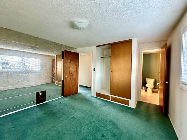 unfurnished bedroom featuring a closet, carpet, and a textured ceiling