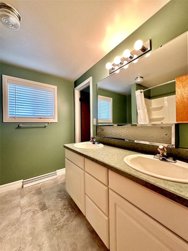 bathroom featuring double vanity, a shower with curtain, a sink, and visible vents