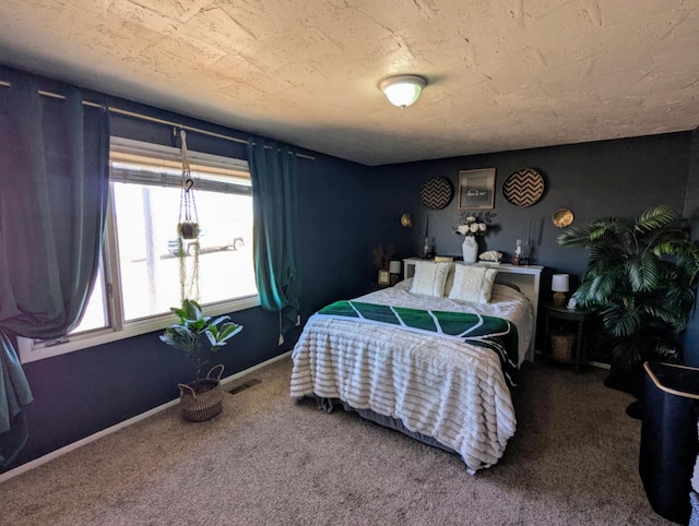 bedroom with carpet flooring, baseboards, and visible vents