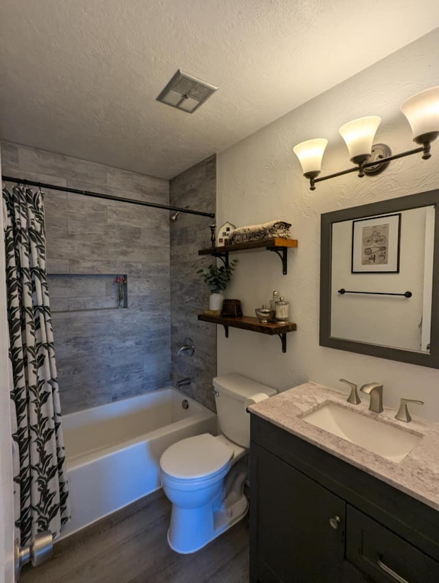 full bathroom with vanity, shower / bath combo, a textured ceiling, toilet, and wood finished floors