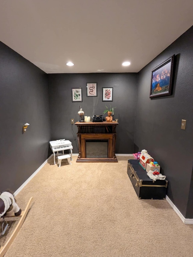 sitting room with carpet floors, baseboards, recessed lighting, and a fireplace