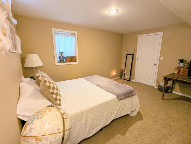 carpeted bedroom featuring baseboards