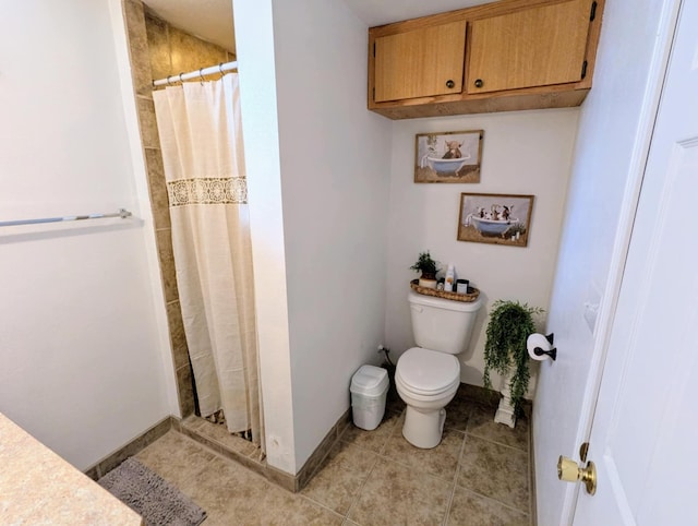 bathroom featuring toilet, tile patterned floors, a shower with shower curtain, and baseboards