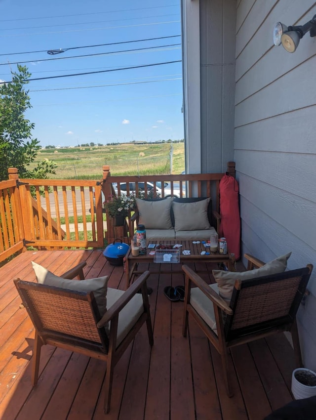 deck with a rural view and an outdoor hangout area