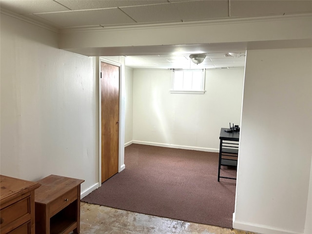 below grade area featuring carpet floors and baseboards