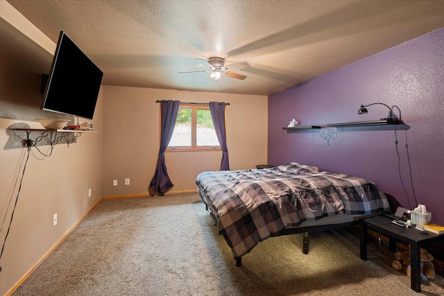 bedroom featuring carpet floors, baseboards, a ceiling fan, and a textured ceiling