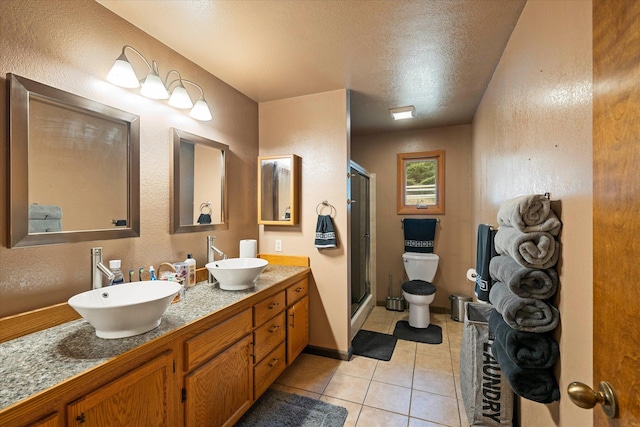 bathroom featuring a textured wall, a sink, and toilet