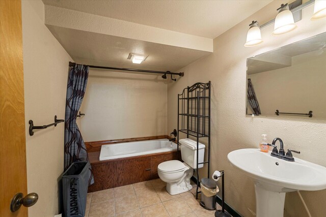 full bathroom with a sink, toilet, shower / bath combo with shower curtain, and tile patterned flooring