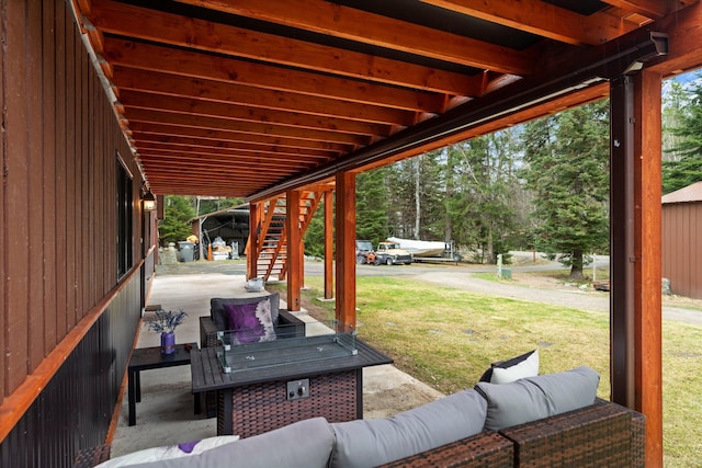 view of patio featuring stairs and an outdoor living space