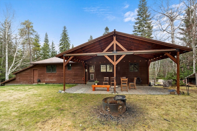 back of house with a patio, a yard, and an outdoor fire pit
