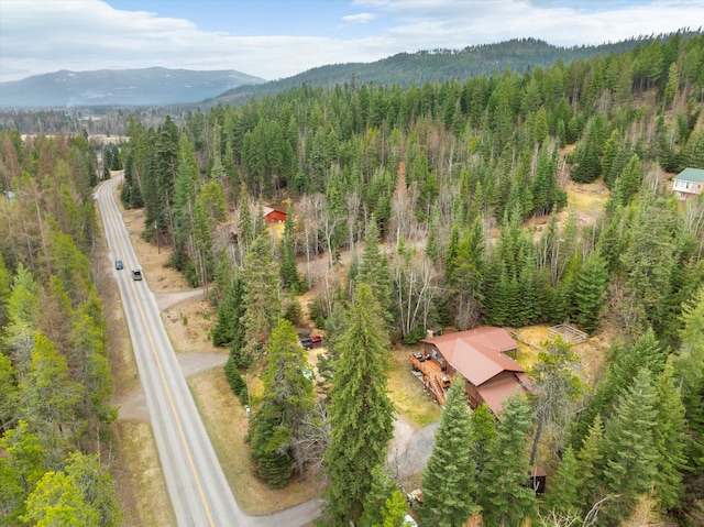 bird's eye view featuring a wooded view and a mountain view
