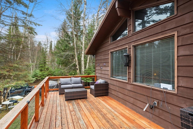wooden terrace featuring outdoor lounge area