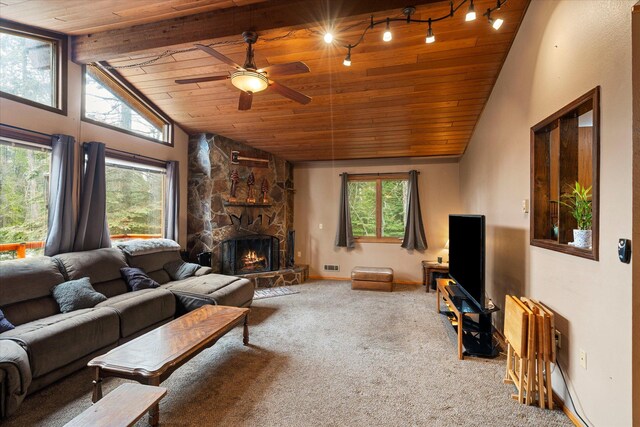 living area with carpet floors, a ceiling fan, a fireplace, and wood ceiling
