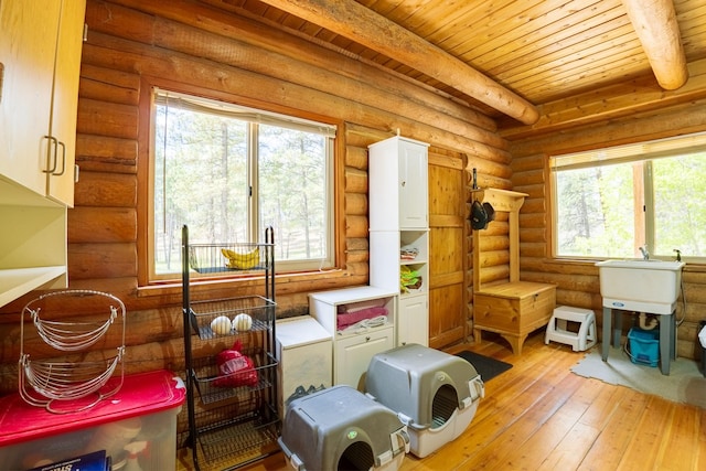 5228 Sophie Lake Rd, Eureka, MT 59917 - misc room with rustic walls, light wood-style flooring, and wood ceiling with exposed beams