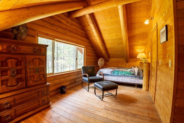 5228 Sophie Lake Rd, Eureka, MT 59917 - bedroom with light wood-style floors, wooden ceiling, and log walls