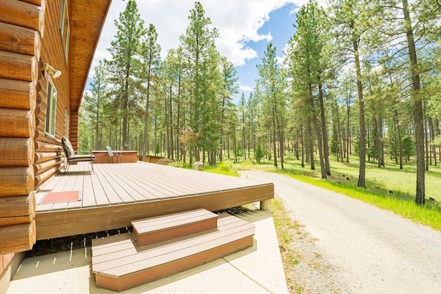 5228 Sophie Lake Rd, Eureka, MT 59917 - wooden terrace featuring a wooded view