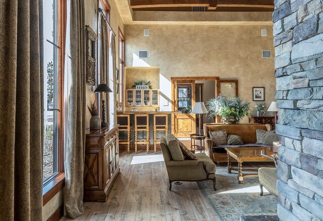 6104 Monterra Ave Unit A, Whitefish, MT 59937 - living area featuring hardwood / wood-style flooring, a high ceiling, and beamed ceiling