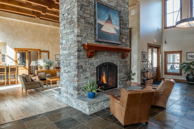 6104 Monterra Ave Unit A, Whitefish, MT 59937 - living area with a high ceiling, a fireplace, and stone tile flooring