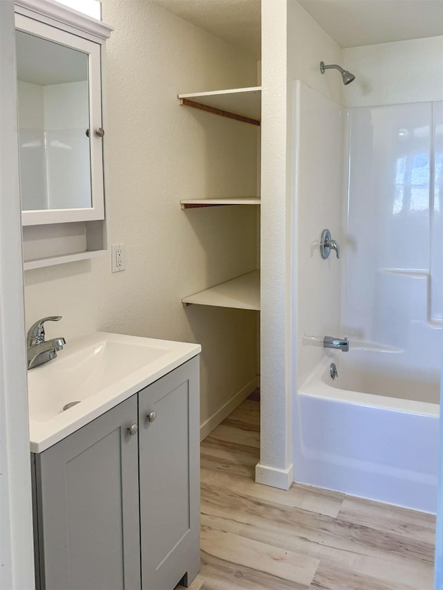 123 W Jefferson Ave, Chester, MT 59522 - bathroom with vanity, wood finished floors, and shower / tub combination