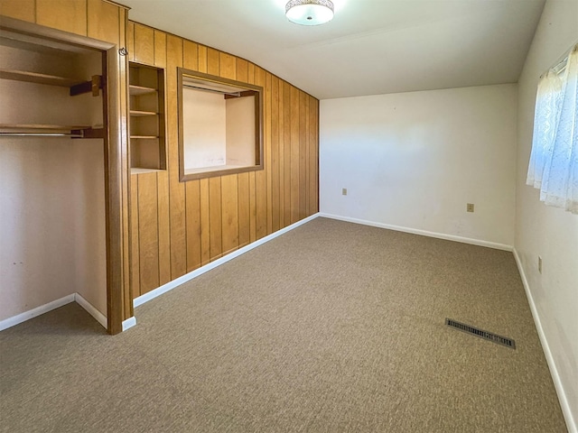 123 W Jefferson Ave, Chester, MT 59522 - unfurnished bedroom with carpet floors, wooden walls, a closet, and lofted ceiling