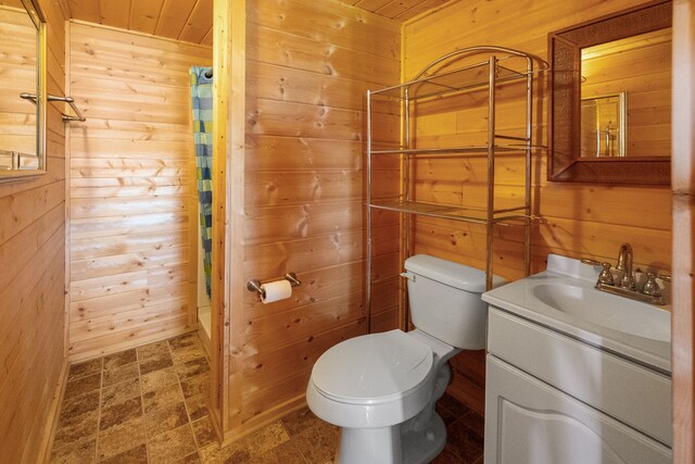 68 Bieler Ln, Sheridan, MT 59749 - bathroom with wooden walls, toilet, vanity, wood ceiling, and curtained shower