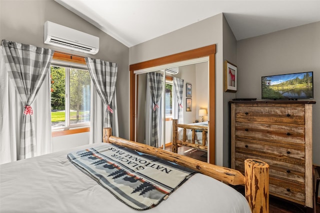 1750 E Lakeshore Dr Unit 203, Whitefish, MT 59937 - bedroom featuring an AC wall unit, lofted ceiling, and a wall mounted AC