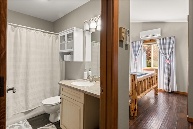 1750 E Lakeshore Dr Unit 203, Whitefish, MT 59937 - full bath featuring an AC wall unit, vanity, a shower with shower curtain, and wood finished floors
