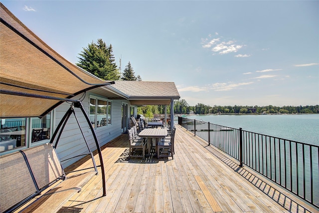 1750 E Lakeshore Dr Unit 203, Whitefish, MT 59937 - wooden deck with outdoor dining space and a water view