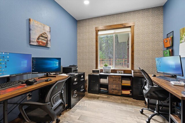 388 Cherry Creek Rd, Thompson Falls, MT 59873 - office area featuring wallpapered walls, light wood finished floors, and an accent wall