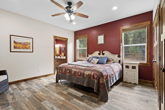 388 Cherry Creek Rd, Thompson Falls, MT 59873 - bedroom featuring wood finished floors, recessed lighting, multiple windows, ensuite bath, and ceiling fan