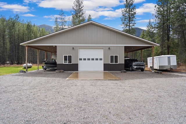 388 Cherry Creek Rd, Thompson Falls, MT 59873 - view of property exterior featuring a mountain view, a detached garage, an outdoor structure, and driveway