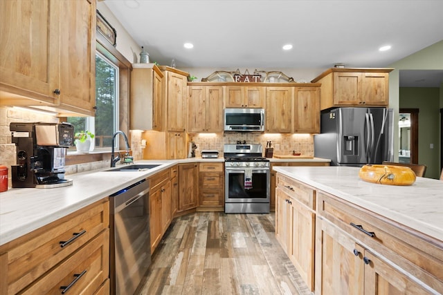 388 Cherry Creek Rd, Thompson Falls, MT 59873 - kitchen with appliances with stainless steel finishes, light wood-type flooring, light countertops, backsplash, and recessed lighting