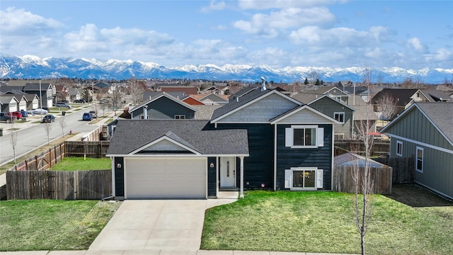 227 Jackson Peak Dr, Kalispell, MT 59901 - traditional home featuring a residential view, roof with shingles, fence private yard, driveway, and a front lawn