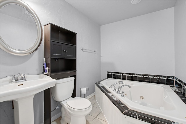 227 Jackson Peak Dr, Kalispell, MT 59901 - bathroom featuring baseboards, a sink, toilet, a tub with jets, and tile patterned flooring