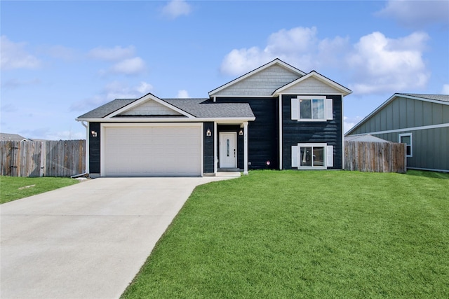 227 Jackson Peak Dr, Kalispell, MT 59901 - tri-level home with driveway, a garage, fence, and a front yard