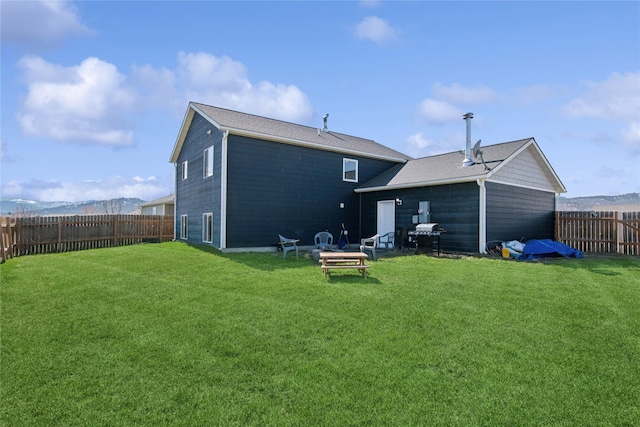 227 Jackson Peak Dr, Kalispell, MT 59901 - back of house with a yard and a fenced backyard