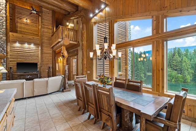 3700 Glen Lake Rd, Eureka, MT 59917 - dining area featuring a high ceiling, a chandelier, light tile patterned flooring, and wood walls
