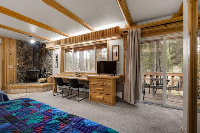3700 Glen Lake Rd, Eureka, MT 59917 - bedroom featuring beamed ceiling, light colored carpet, multiple windows, access to outside, and a wood stove
