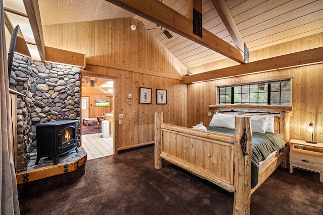 3700 Glen Lake Rd, Eureka, MT 59917 - bedroom featuring a wood stove, carpet, wooden walls, high vaulted ceiling, and a wood ceiling with exposed beams