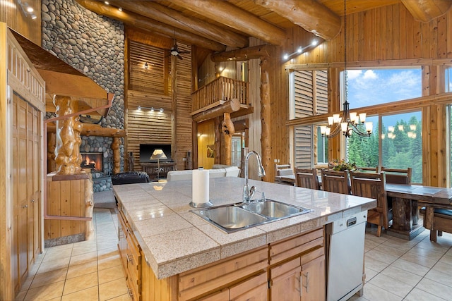 3700 Glen Lake Rd, Eureka, MT 59917 - kitchen with a wood ceiling with exposed beams, a high ceiling, light tile patterned floors, a stone fireplace, and dishwasher