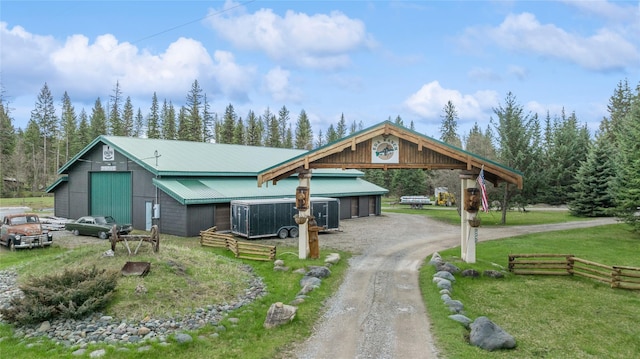3700 Glen Lake Rd, Eureka, MT 59917 - view of front of house with dirt driveway, a front yard, a metal roof, and a detached carport